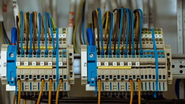 Zaciski przyłącza elektrycznego z kolorowymi przewodami, uporządkowane i oznaczone numerami.